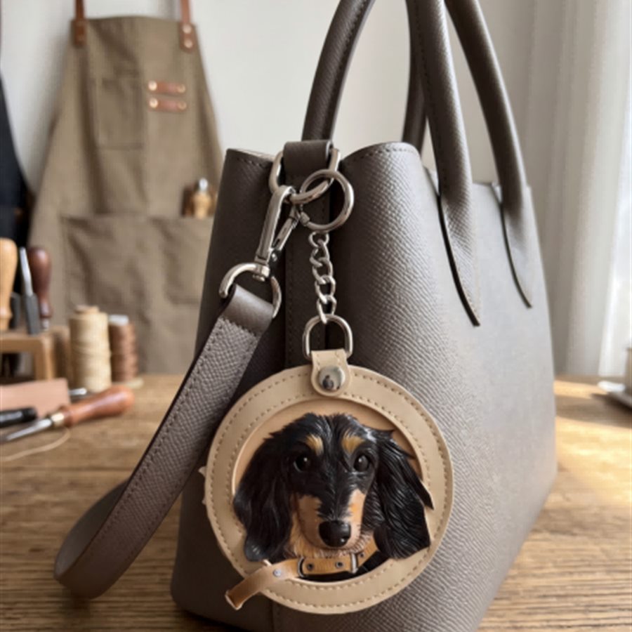 TheAurir leather memory charm attached to a daily handbag.