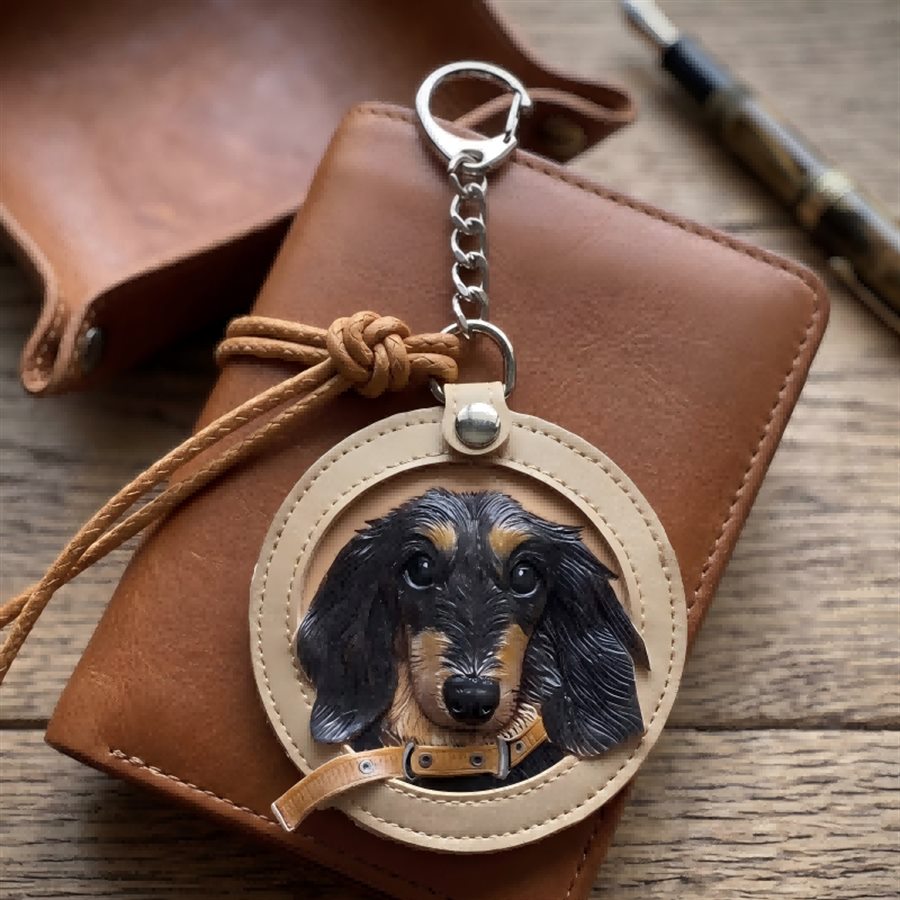 TheAurir leather memory charm attached to a leather wallet.