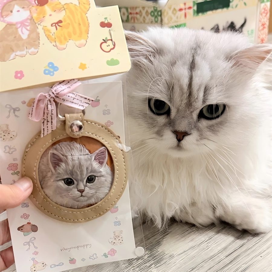 Customer photo of a white cat beside a finished custom leather portrait charm.